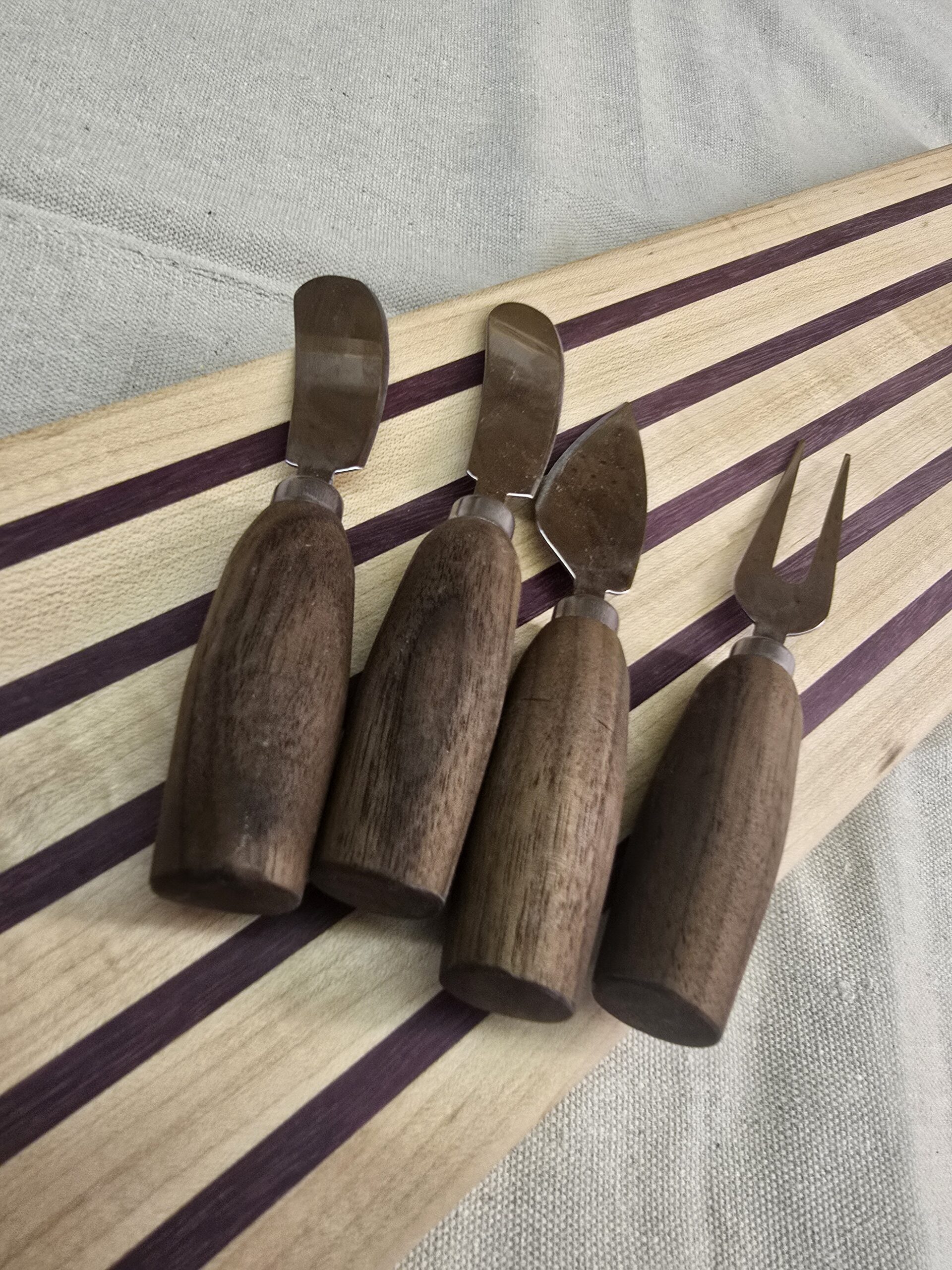 Cutting board with cheese forks and knives